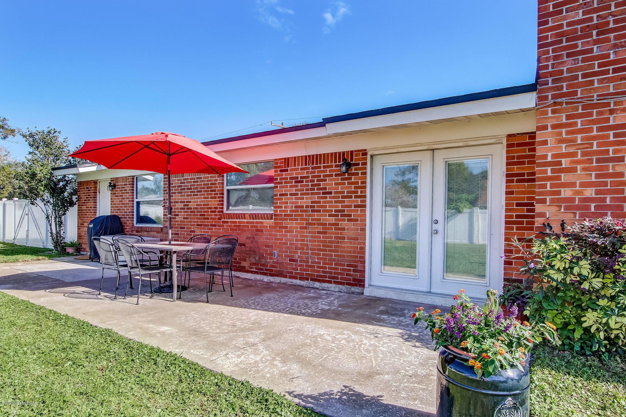 4006 Eunice Road Jacksonville, FL 32250 - Photo 28 of 30 a patio with a table and chairs under an umbrella