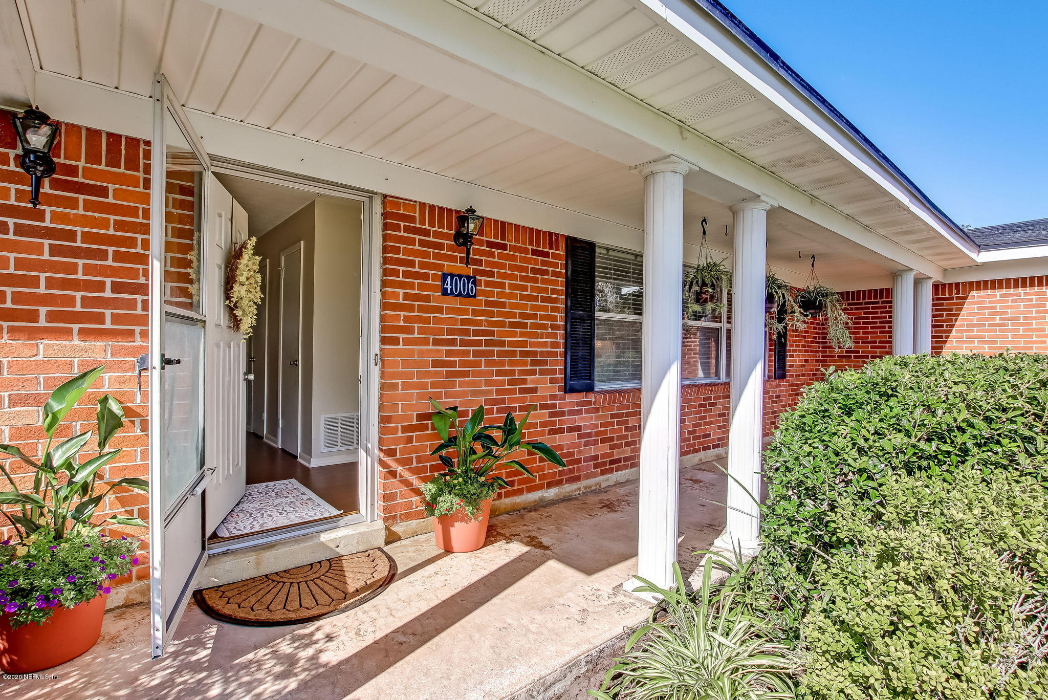 4006 Eunice Road Jacksonville, FL 32250 - Photo 6 of 30 a potted plant sitting in front of a door
