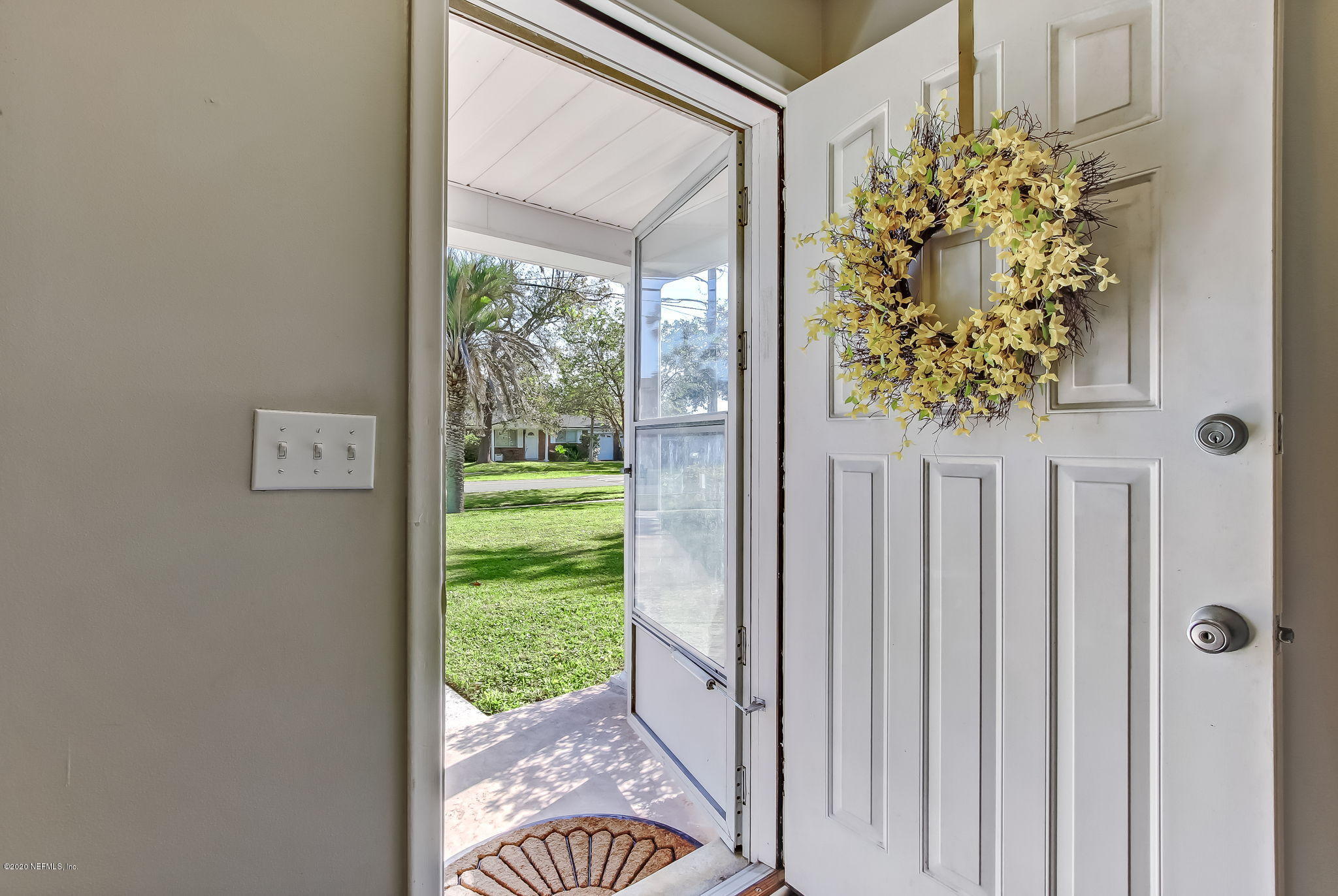 4006 Eunice Road Jacksonville, FL 32250 - Photo 8 of 30 a view of a porch with a floor to ceiling window and garden