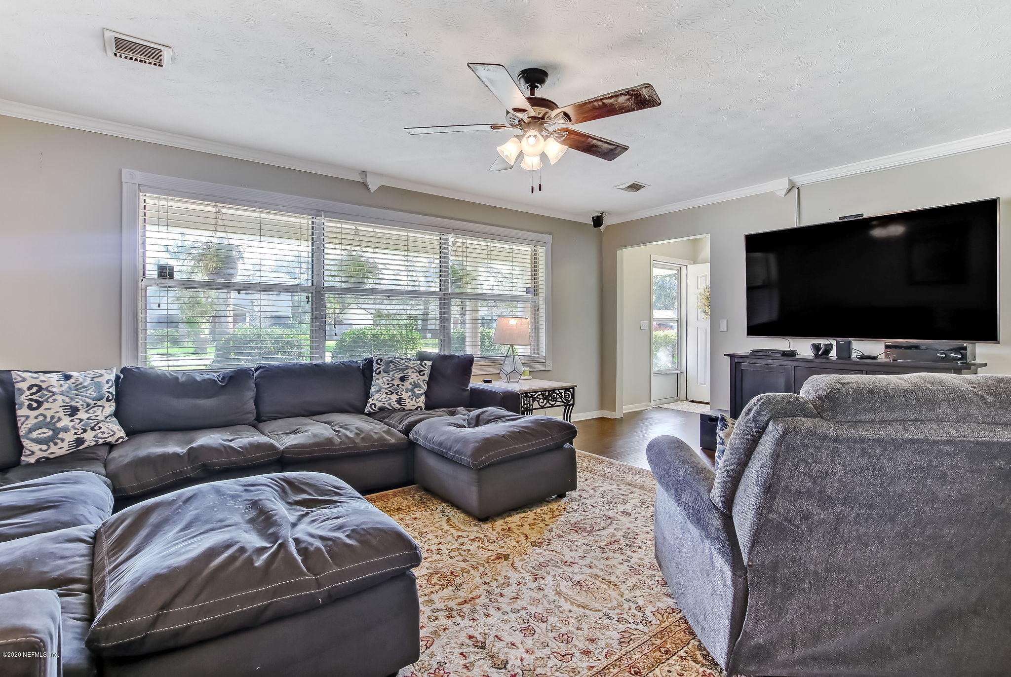 4006 Eunice Road Jacksonville, FL 32250 - Photo 10 of 30 a living room with furniture a flat screen tv and a large window