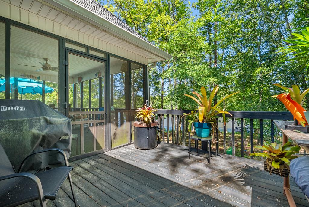 235 Epps Road Box Springs, GA 31801 - Photo 28 of 93 a view of a patio with table and chairs potted plants and floor to ceiling window