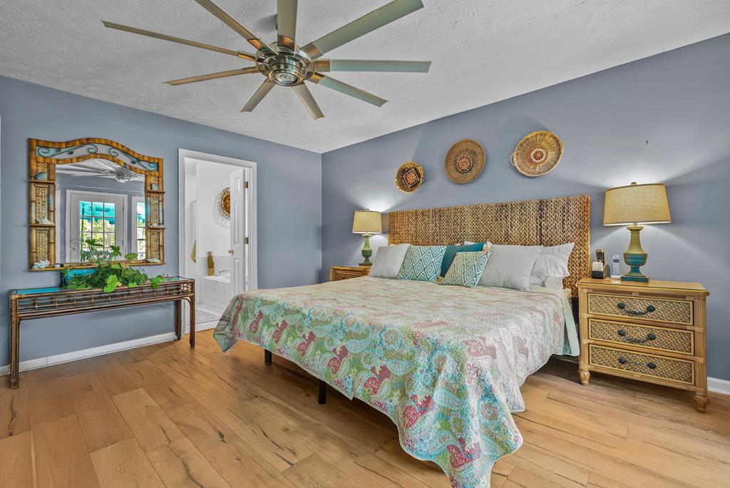 235 Epps Road Box Springs, GA 31801 - Photo 30 of 93 a bedroom with a bed and a chandelier