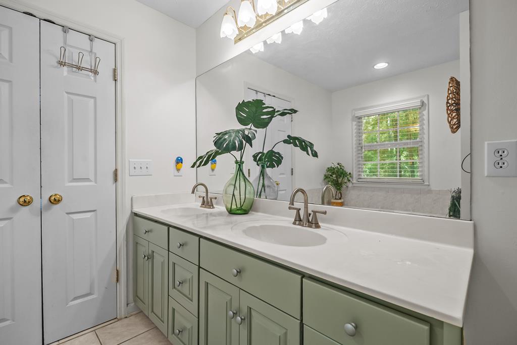 235 Epps Road Box Springs, GA 31801 - Photo 35 of 93 a bathroom with a sink a faucet a mirror and a bathtub with shower