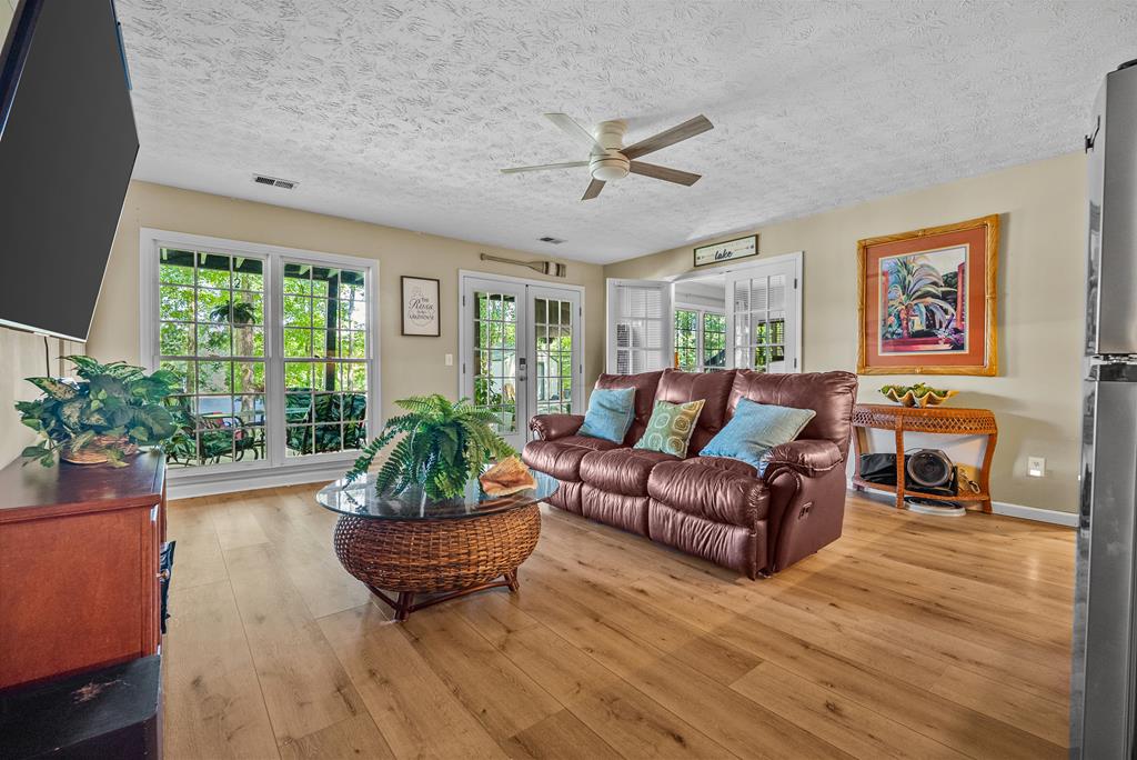 235 Epps Road Box Springs, GA 31801 - Photo 51 of 93 a living room with furniture a large window and wooden floor