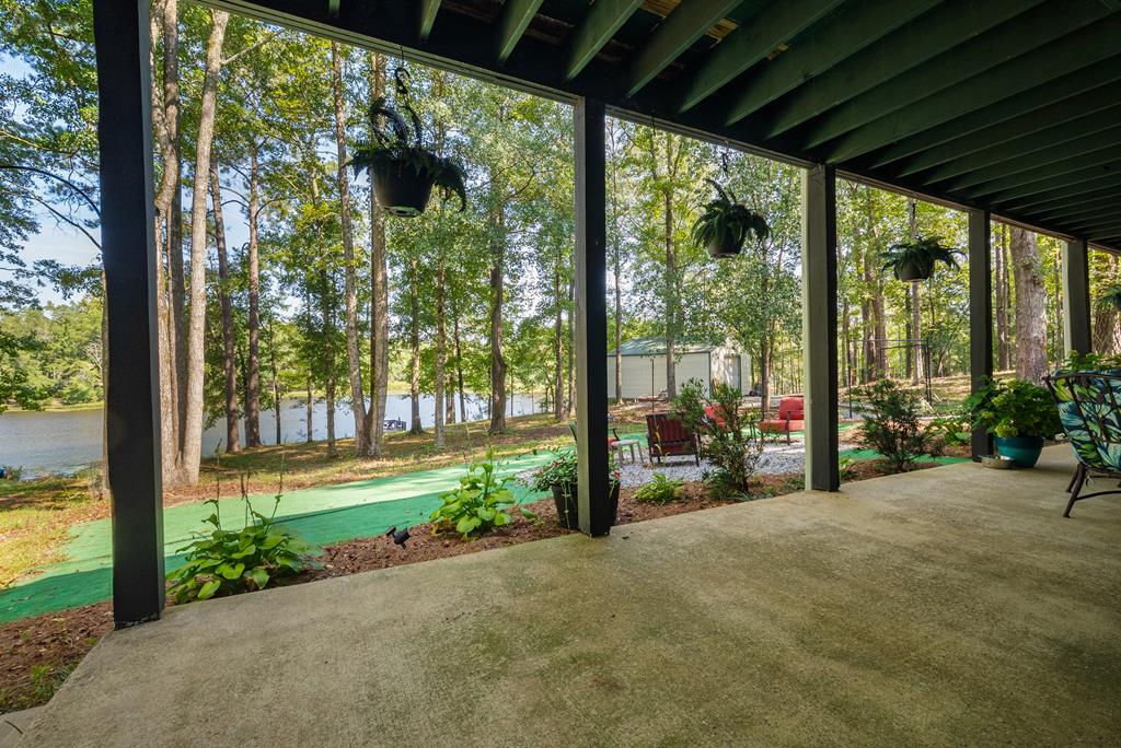 235 Epps Road Box Springs, GA 31801 - Photo 56 of 93 a view of a porch with chairs and floor to ceiling window