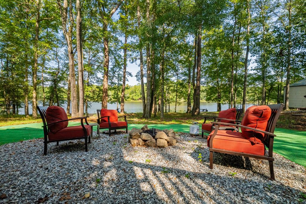 235 Epps Road Box Springs, GA 31801 - Photo 69 of 93 a backyard of a house with fire pit and outdoor seating