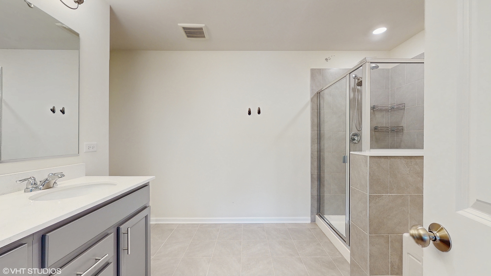 268 Hoffmann Drive, Unit 268 Buffalo Grove, IL 60089 - Photo 22 of 37 a bathroom with a shower sink and mirror