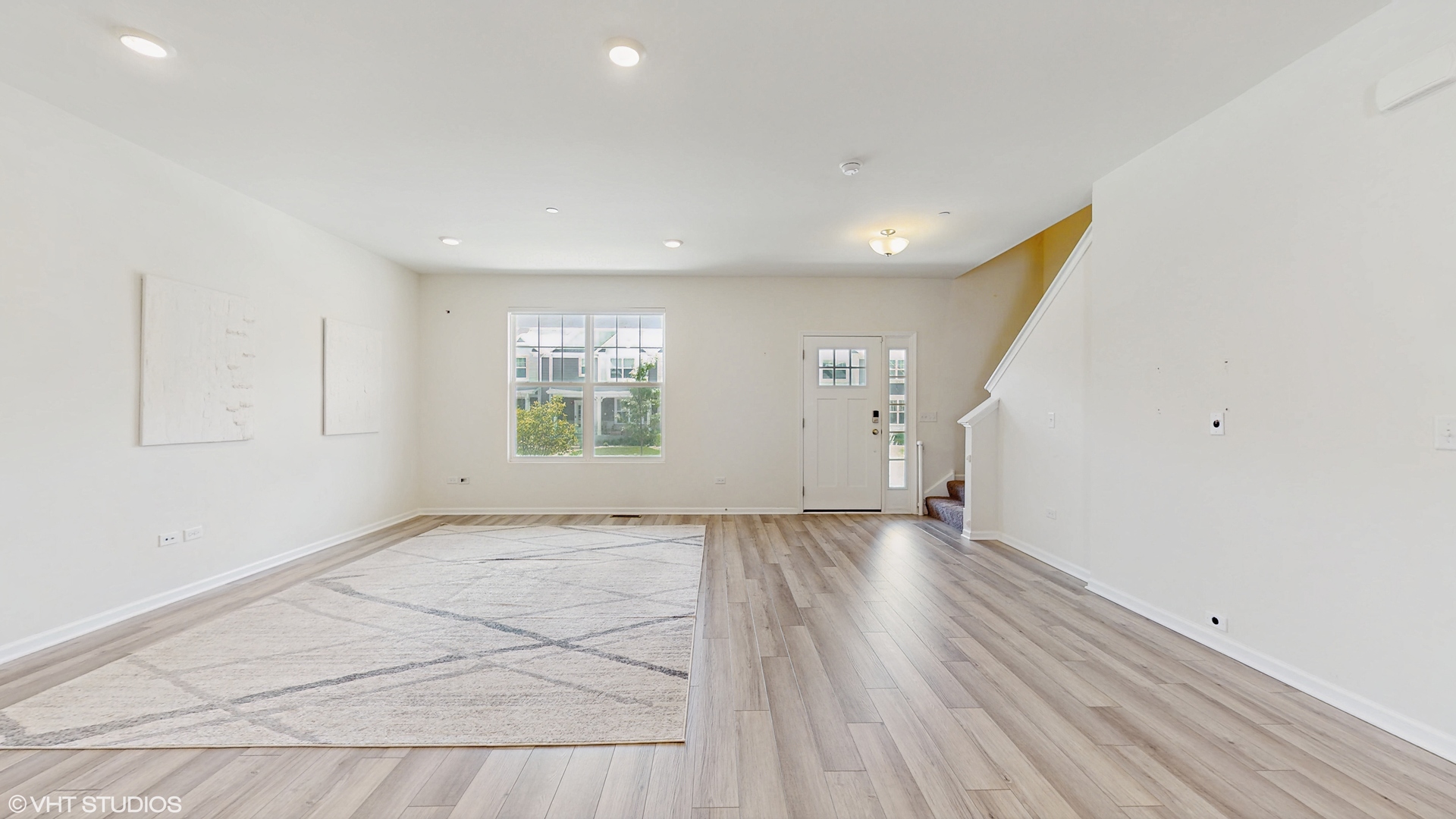 268 Hoffmann Drive, Unit 268 Buffalo Grove, IL 60089 - Photo 8 of 37 an empty room with wooden floor and windows