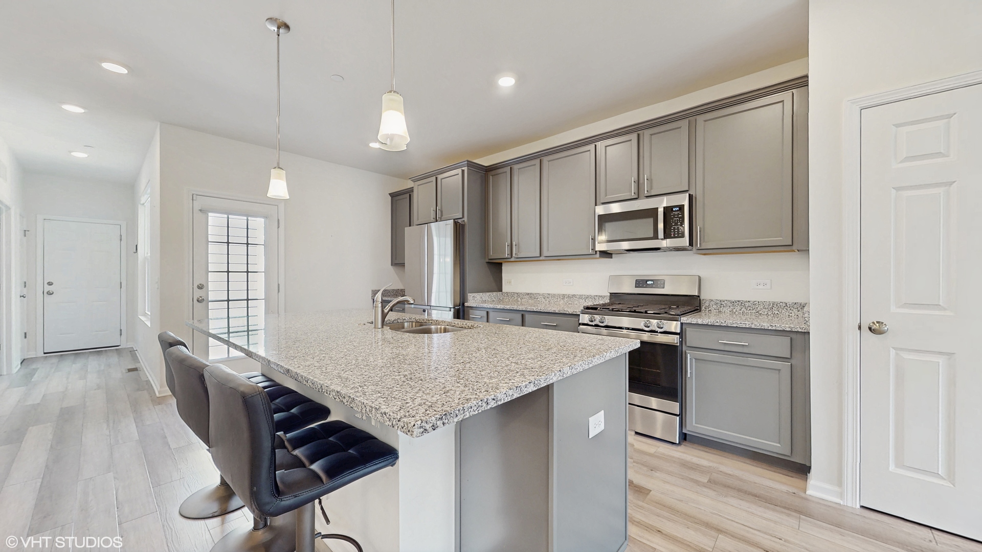 268 Hoffmann Drive, Unit 268 Buffalo Grove, IL 60089 - Photo 10 of 37 a kitchen with kitchen island a stove a sink and a refrigerator with wooden floor