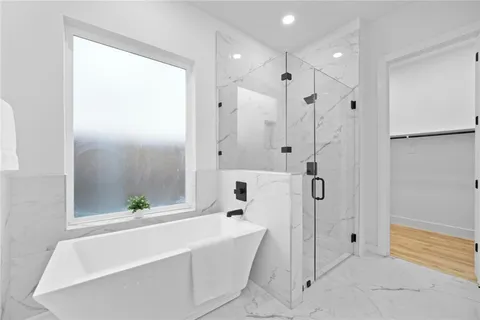 a bathroom with a bathtub and a shower