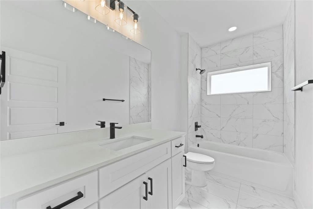 2121 Oak Haven Court Garland, TX 75044 - Photo 24 of 38 a bathroom with a sink a toilet and shower