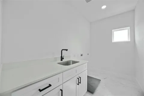 a kitchen with a sink and cabinets