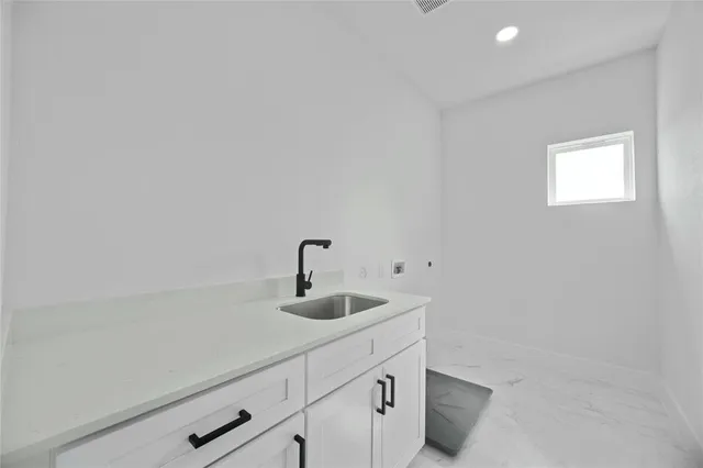 a kitchen with a sink and cabinets