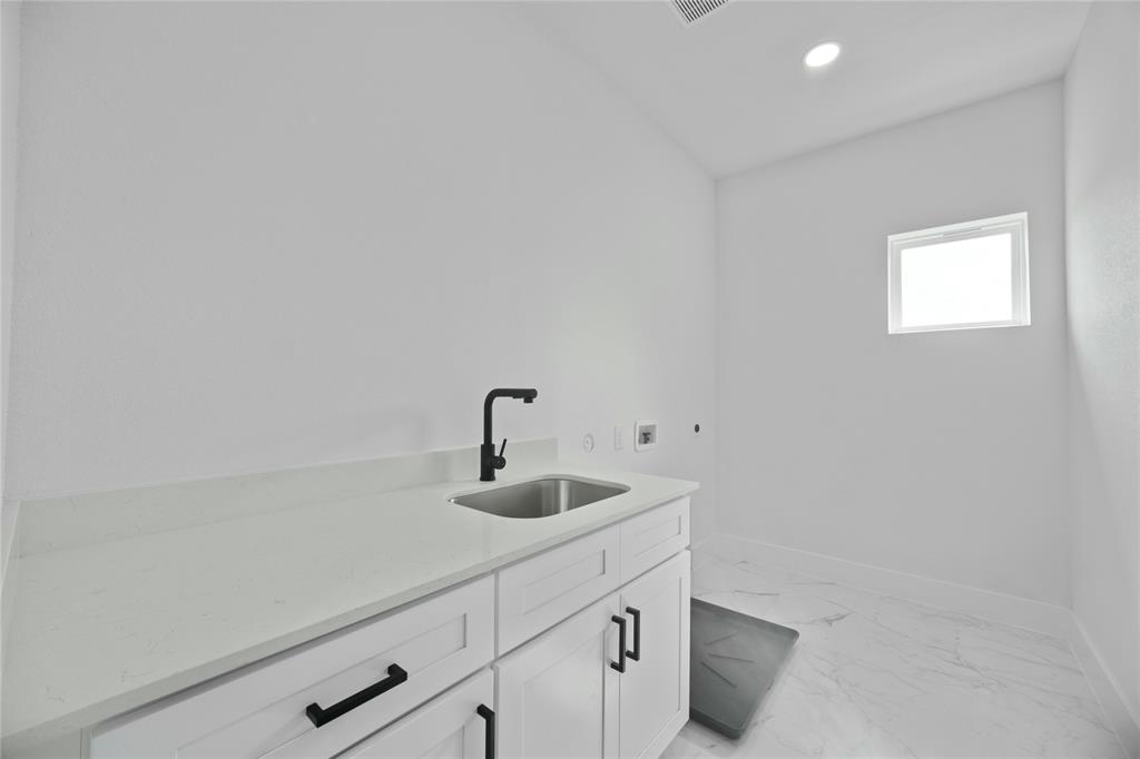 2121 Oak Haven Court Garland, TX 75044 - Photo 25 of 38 a kitchen with a sink and cabinets