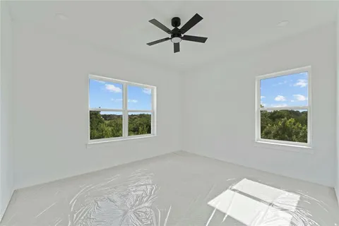 a view of a livingroom with a ceiling fan and window
