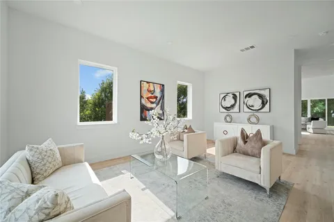 a living room with furniture and painting on the wall