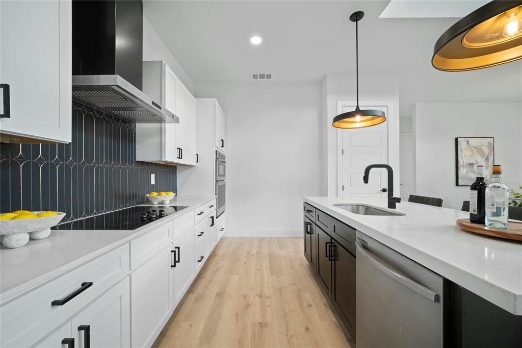2121 Oak Haven Court Garland, TX 75044 - Photo 10 of 38 a kitchen with granite countertop a sink stainless steel appliances and cabinets