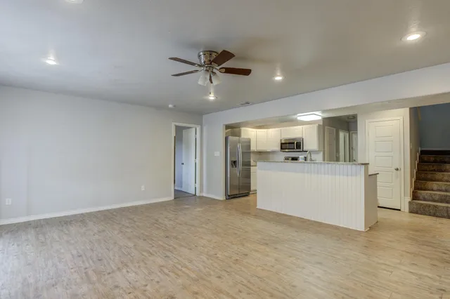 a view of a kitchen with a sink and a refrigerator