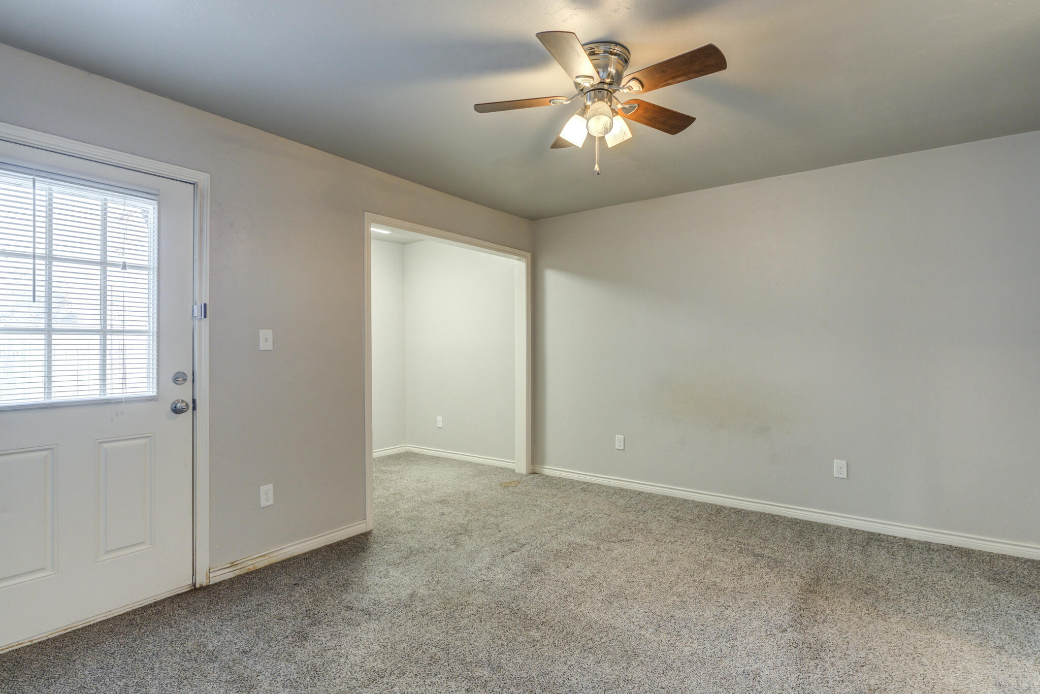 4320 52nd Street Lubbock, TX 79413 - Photo 16 of 59 an empty room with chandelier fan and windows
