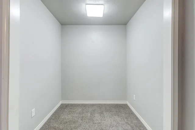 an empty room with cabinet and a bathroom