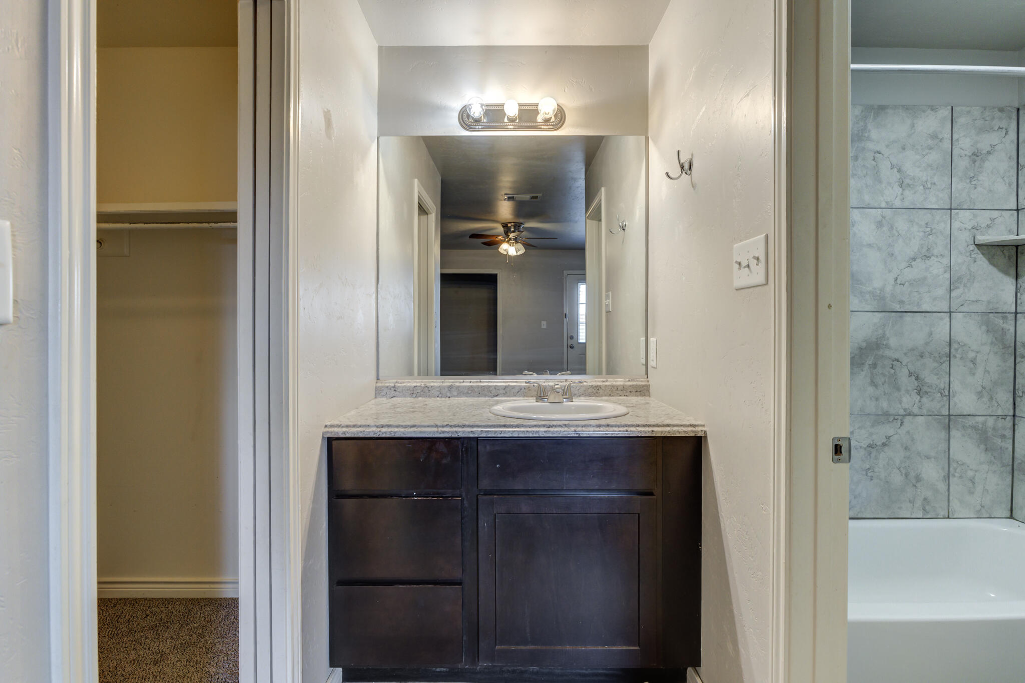 4320 52nd Street Lubbock, TX 79413 - Photo 20 of 59 a bathroom with a sink and a mirror