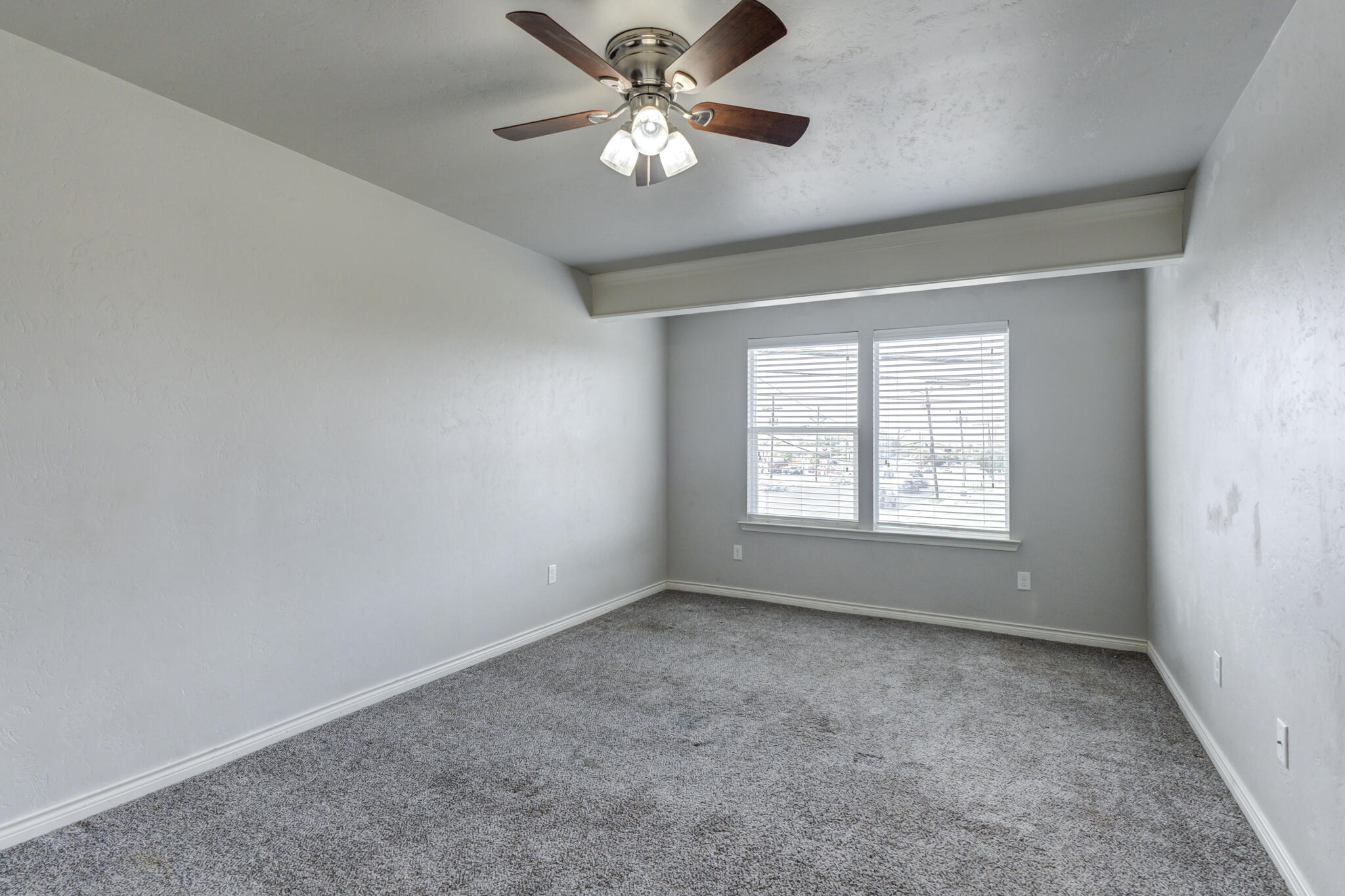 4320 52nd Street Lubbock, TX 79413 - Photo 24 of 59 wooden floor in an empty room with a window