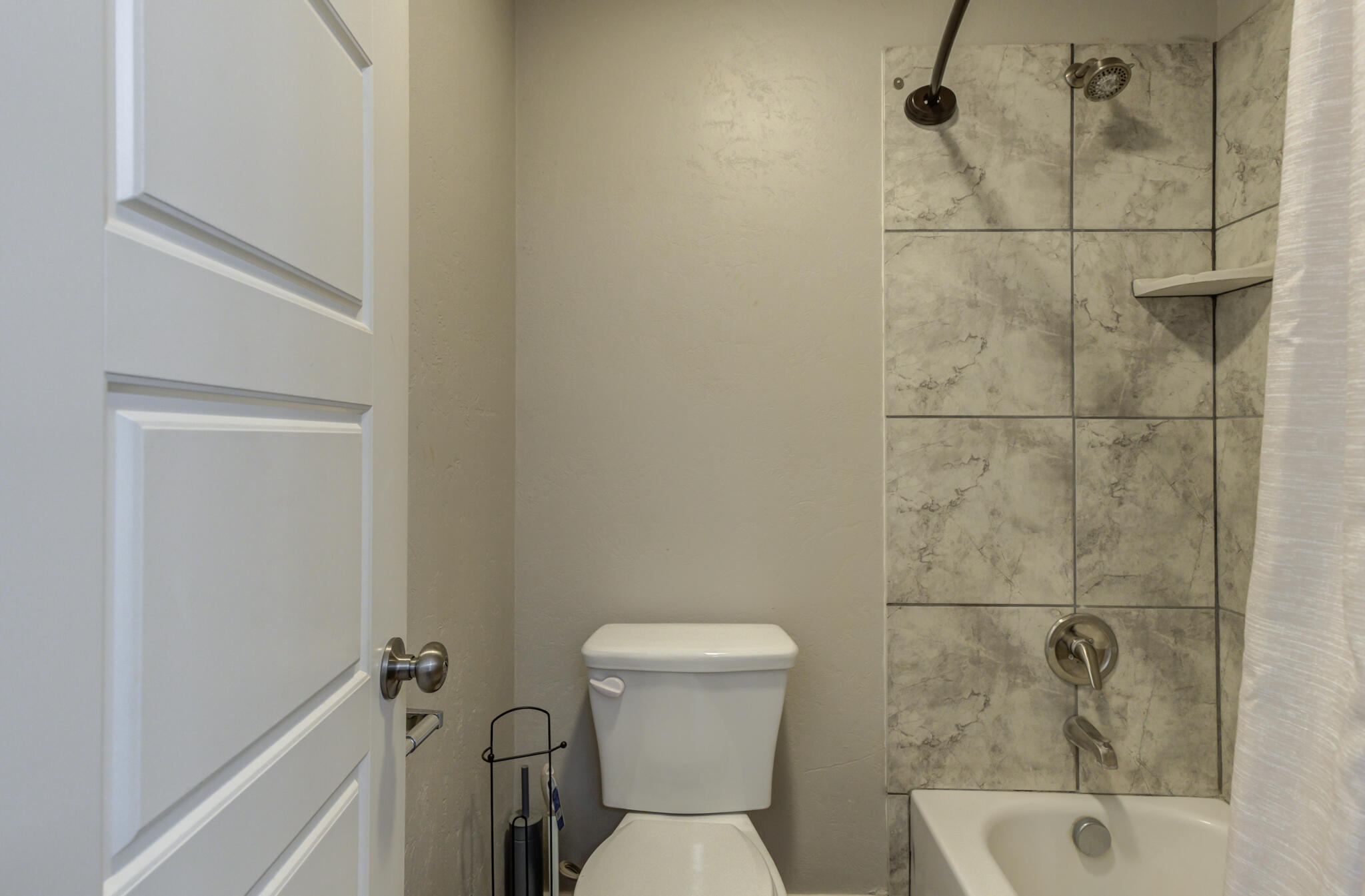 4320 52nd Street Lubbock, TX 79413 - Photo 28 of 59 a bathroom with a toilet and a shower