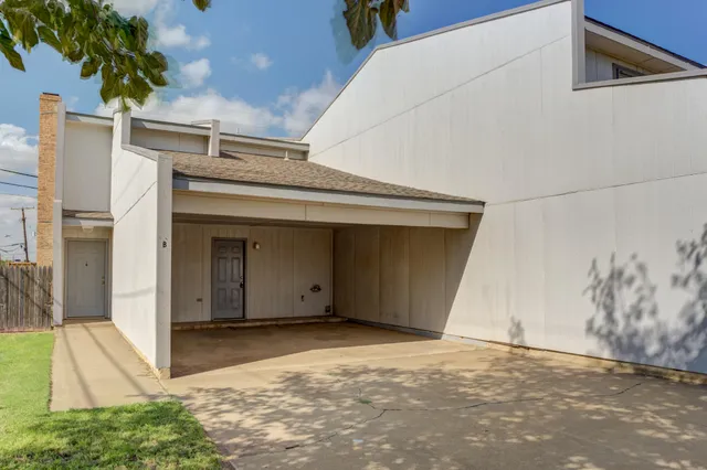 a kitchen with a sink stainless steel appliances and white cabinets