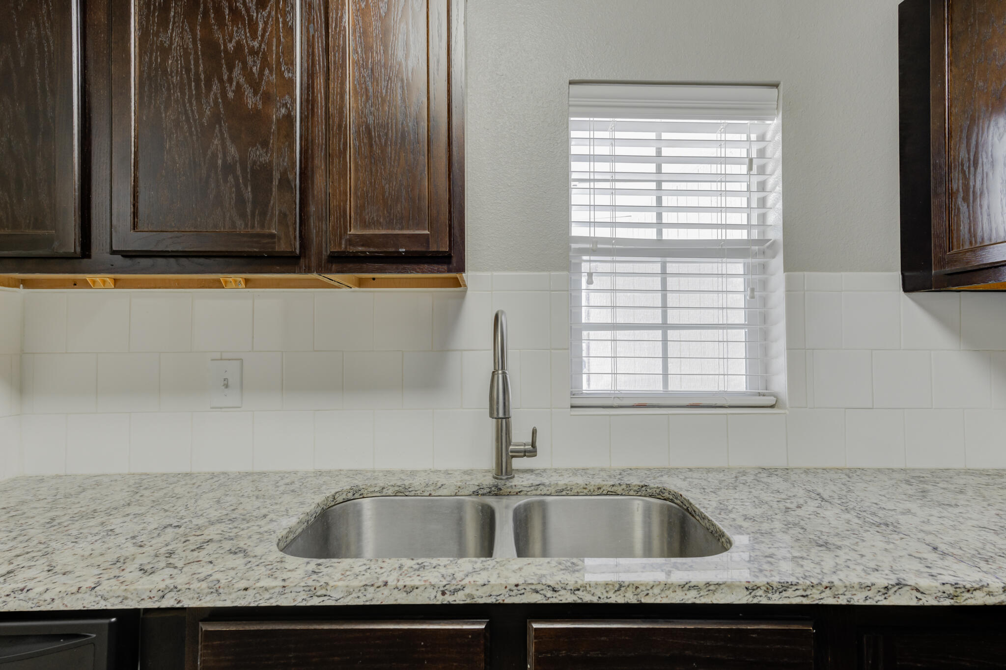 4320 52nd Street Lubbock, TX 79413 - Photo 43 of 59 a kitchen with granite countertop a sink and a granite counter tops