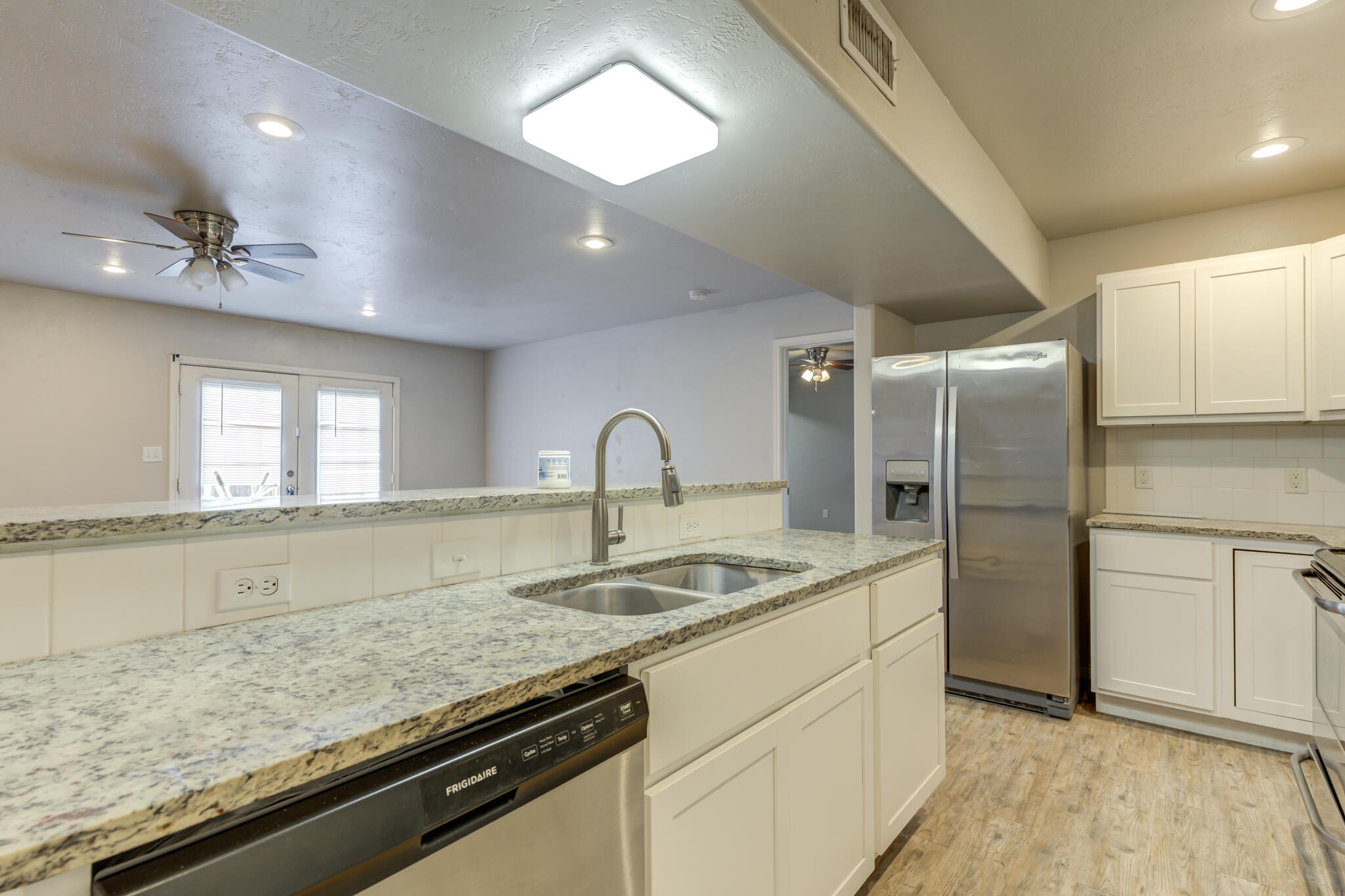 4320 52nd Street Lubbock, TX 79413 - Photo 5 of 59 a kitchen with stainless steel appliances granite countertop a sink stove and refrigerator