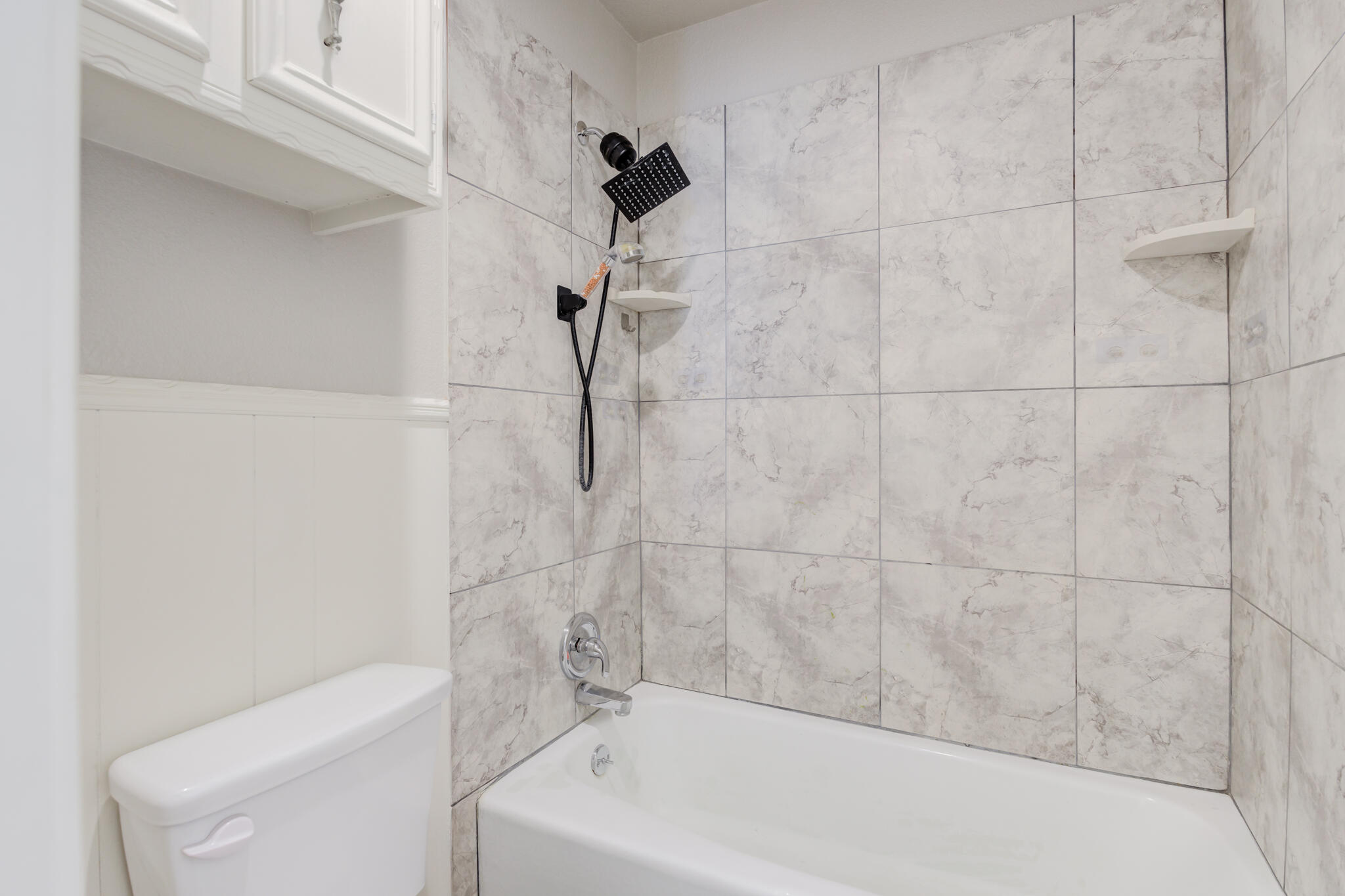 4320 52nd Street Lubbock, TX 79413 - Photo 55 of 59 a bathroom with a white bath tub and a shower