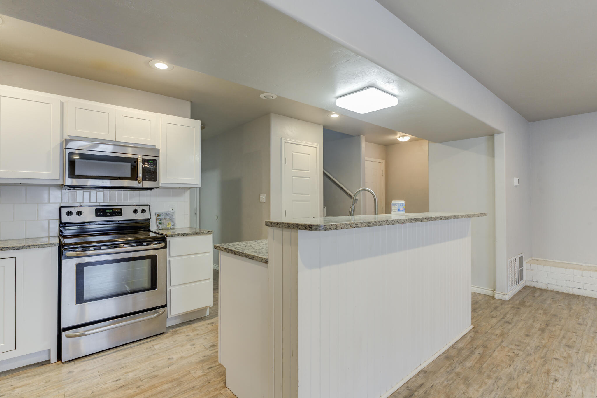 4320 52nd Street Lubbock, TX 79413 - Photo 9 of 59 a kitchen with stainless steel appliances a stove microwave and sink