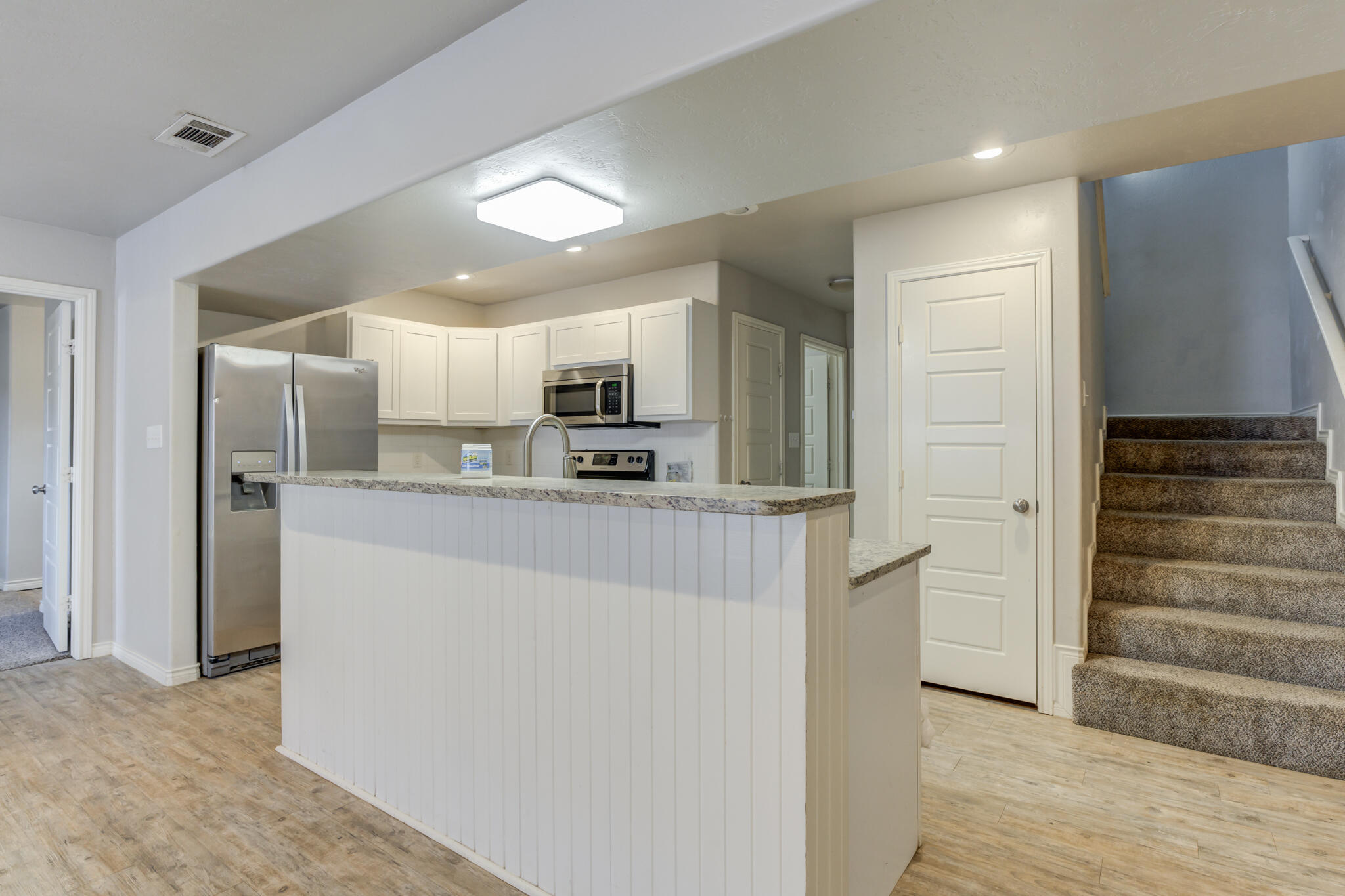 4320 52nd Street Lubbock, TX 79413 - Photo 10 of 59 a view of a kitchen with wooden floor and electronic appliances