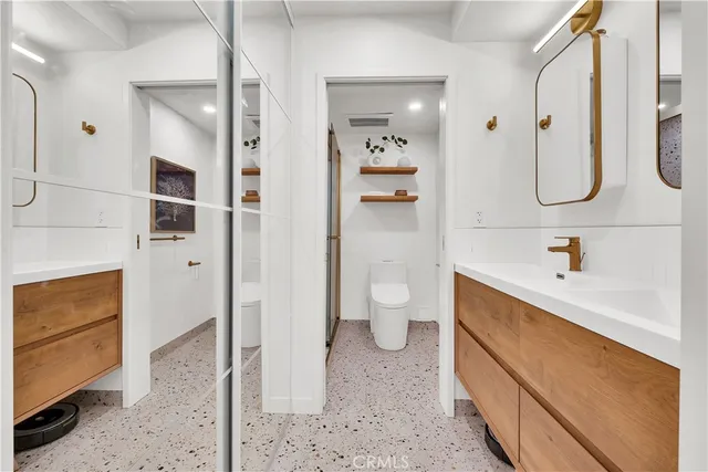 a bathroom with a bathtub shower sink and toilet