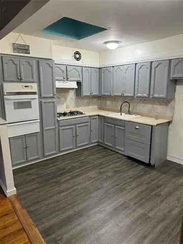 a kitchen with stainless steel appliances granite countertop a sink and cabinets