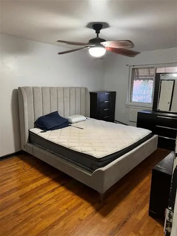 a bed sitting in a bedroom next to a window with a chandelier
