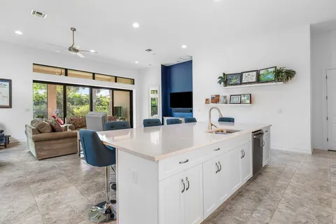 a large white kitchen with a large window
