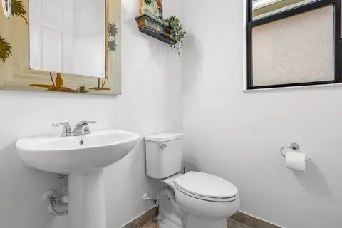 a bathroom with a sink toilet and mirror
