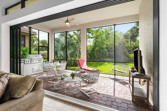 a living room with couch and a floor to ceiling window