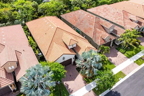 an aerial view of a house with a yard and a fountain