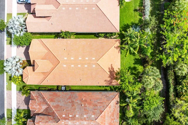 an aerial view of a house with a garden and plants