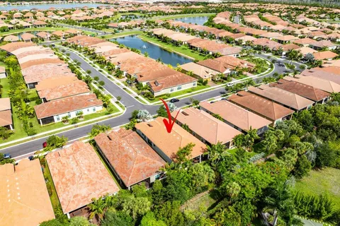 a front view of a house with a yard and garden