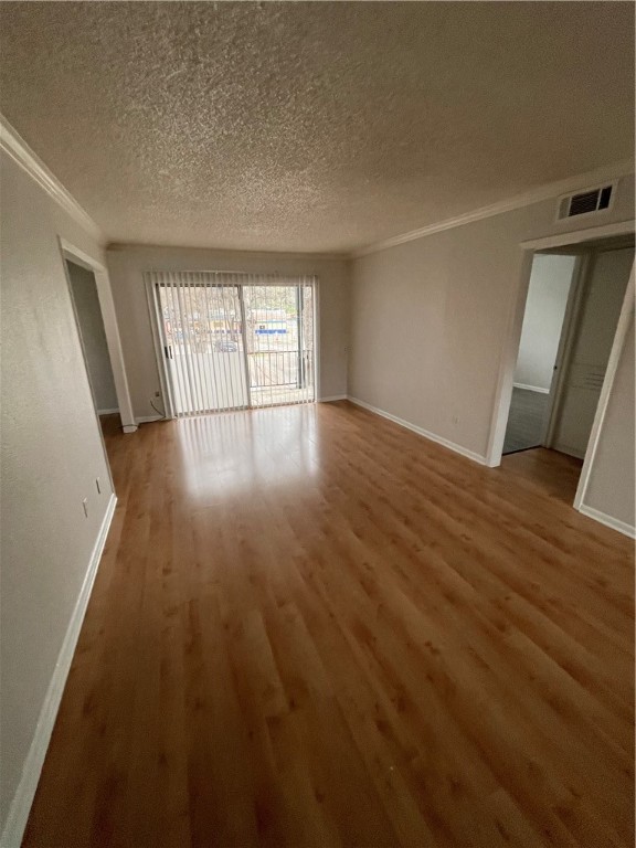 1725 Toomey Road, Unit 307 Austin, TX 78704 - Photo 4 of 12 an empty room with wooden floor and windows