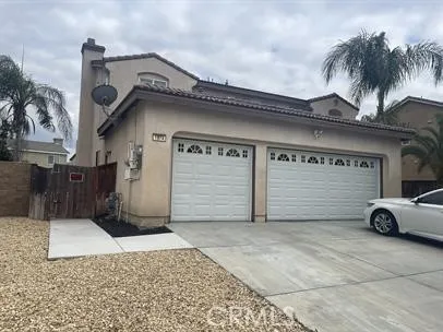 a front view of a house with parking area