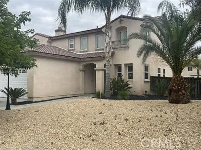 a front view of house with yard and trees around