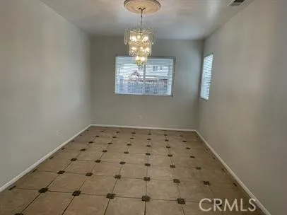 a view of a hallway with a chandelier fan