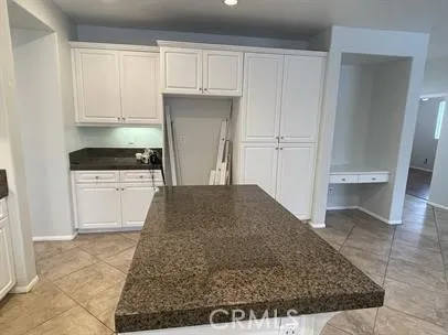 a kitchen with white cabinets