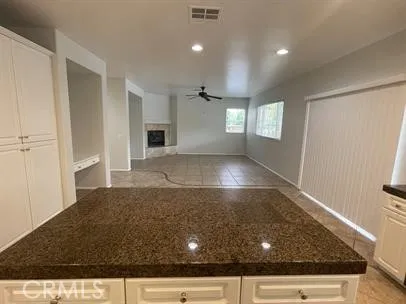 an empty room with windows and fireplace