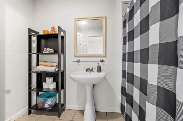 a bathroom with a sink a mirror and shower