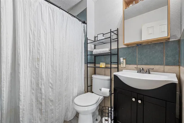 a bathroom with a sink toilet and vanity